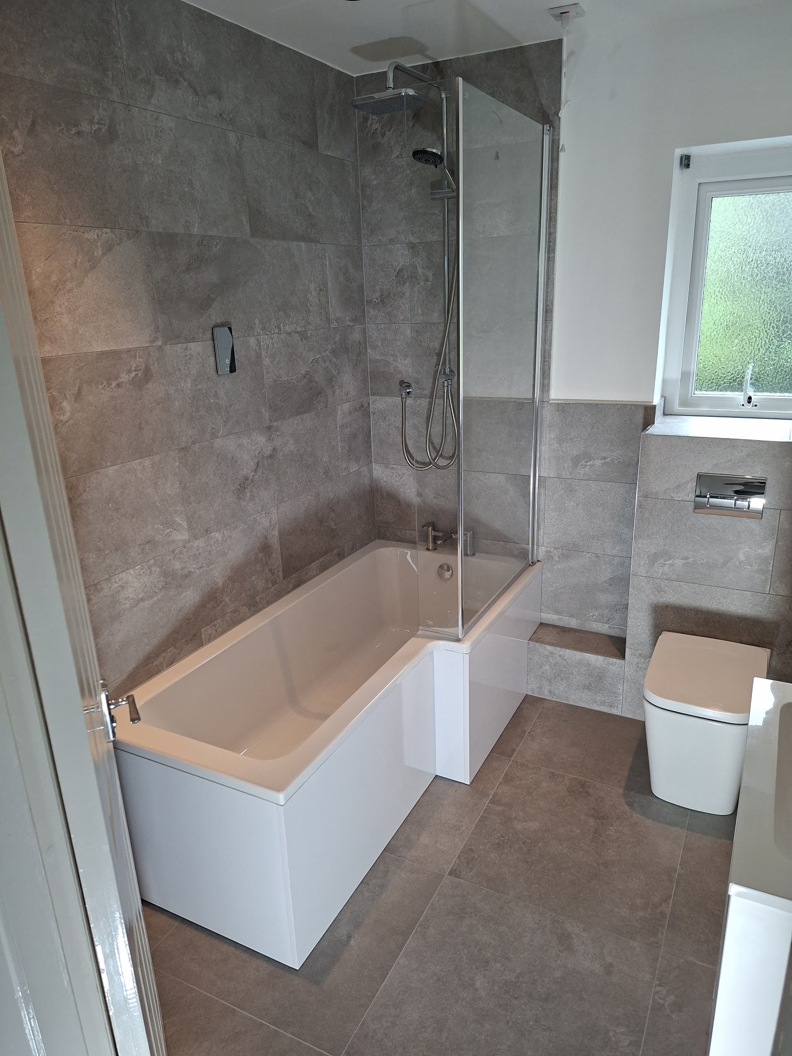 Marble-effect bathroom with bath and shower, Plymouth