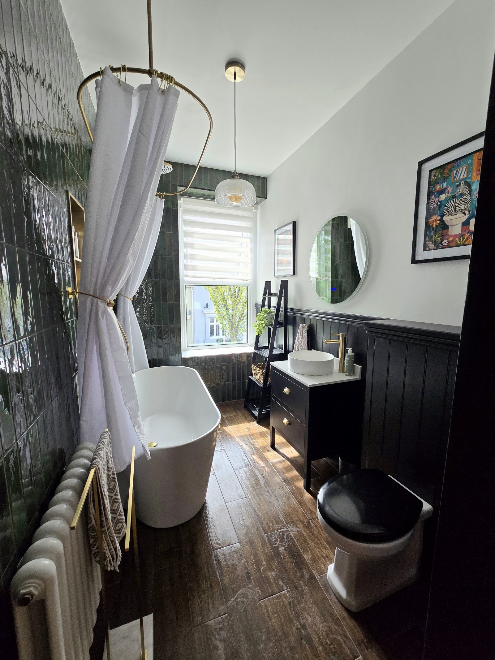 Dark green tiled bathroom with freestanding bath and brass fittings, Plymouth