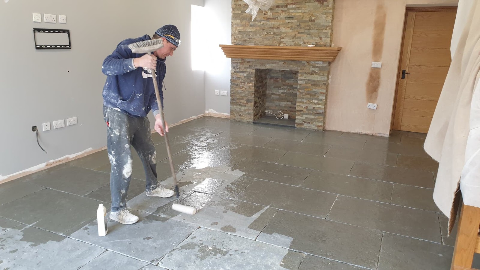 Tiling and House Renovation laying a tiled floor on a job in Plymouth